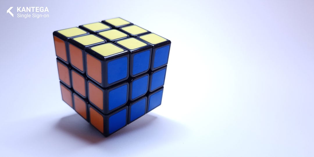 A solved Rubik's cube with blue, yellow and red sides on a white background